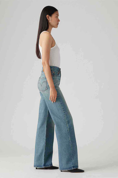 Blue denim wide-leg jeans, side view with high-rise waist