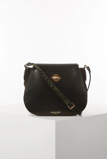 Black crossbody shoulder bag with gold logo clasp and front logo text