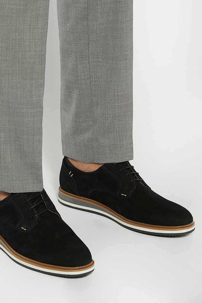 Black lace-up suede shoes, side view, with tan edge and white sole