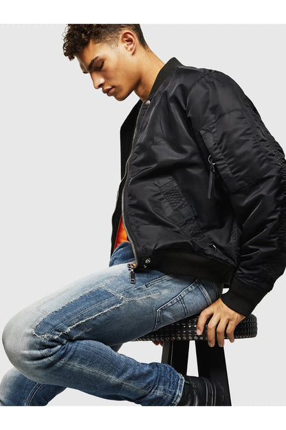 Diesel denim jeans, light blue wash, distressed knee rips and stitched pockets.