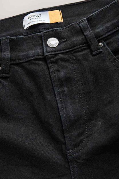 Black jeans label and button closure on waistband