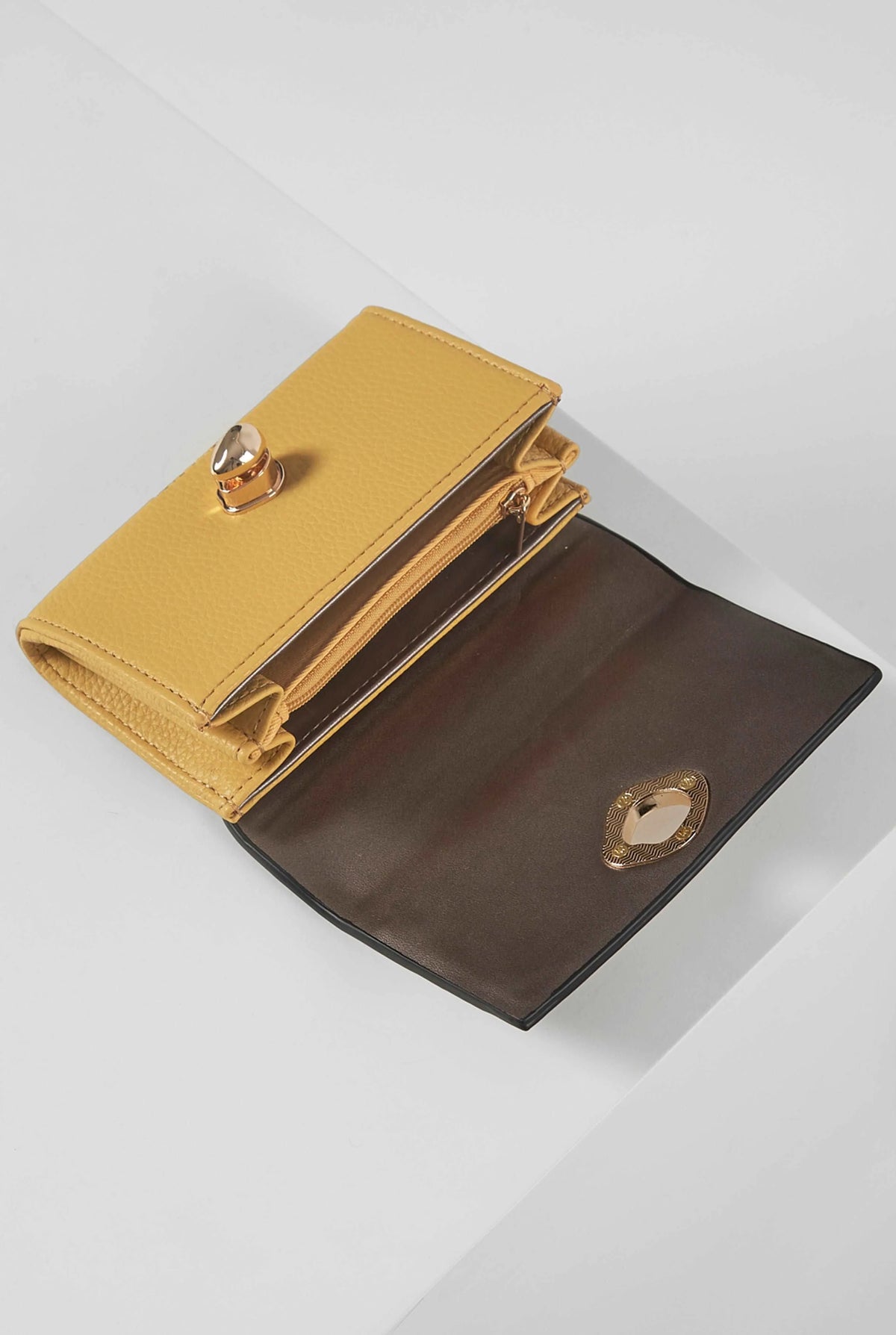 Open yellow wallet with gold-toned snap, dark interior lining, and card slots