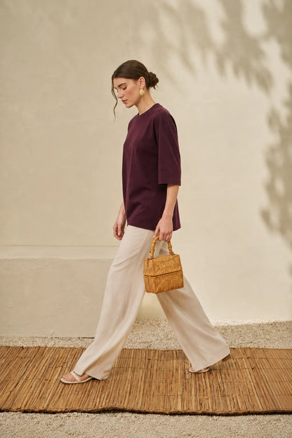 Maroon crew-neck T-shirt with elbow-length sleeves, worn with loose pants
