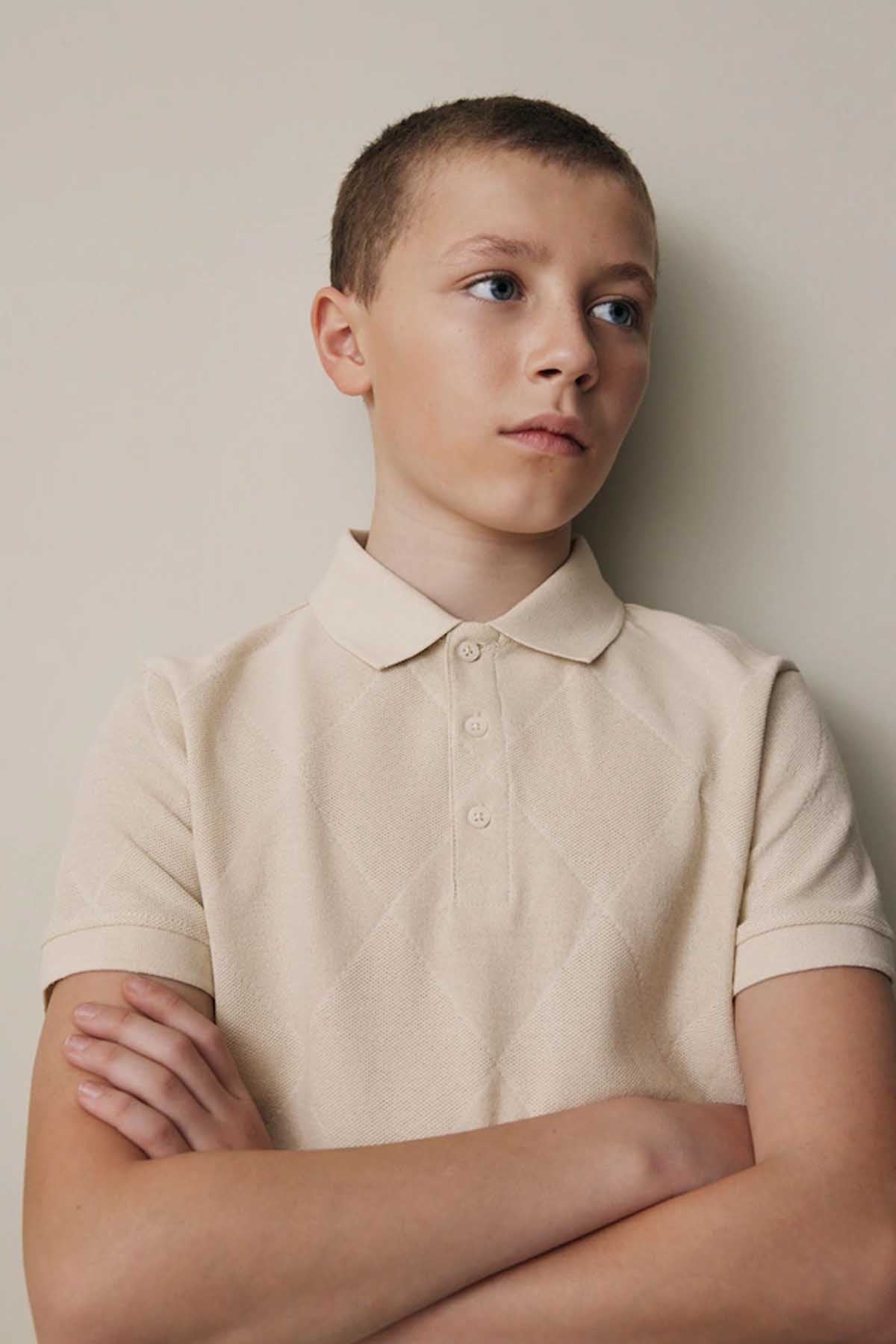 NEXT cream polo shirt, close view with folded collar and buttons