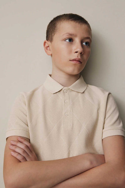 NEXT cream polo shirt, close view with folded collar and buttons