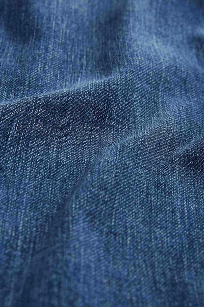 Blue denim fabric texture close-up, woven twill