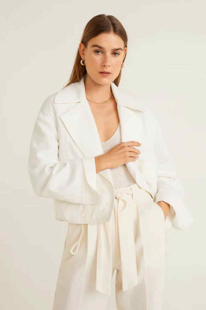Women's cream tie-waist trousers with paper-bag waist detail, close-up