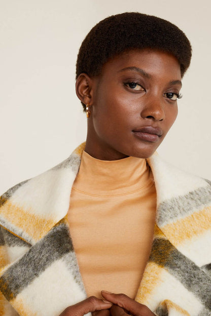 Beige long-sleeve turtleneck top, close-up collar