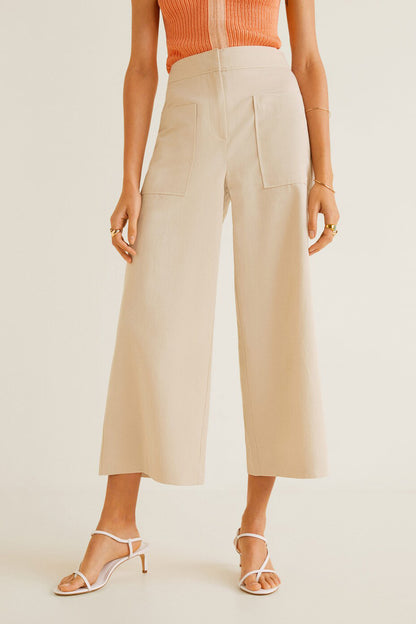 MANGO ecru wide-leg trousers with side pockets, styled with orange ribbed sleeveless top