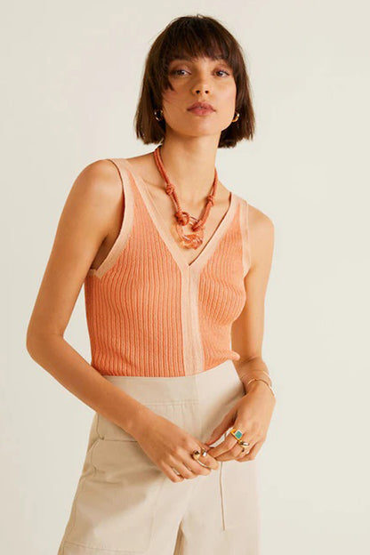 MANGO two-piece outfit: orange V-neck sleeveless top and ecru cropped wide-leg pants