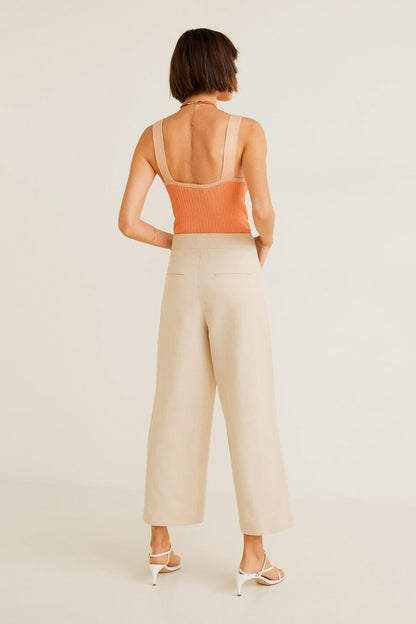 MANGO two-piece outfit: orange sleeveless ribbed top with ecru wide-leg trousers