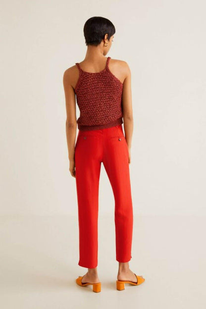 Coral red sleeveless knit top and ankle-length trousers, back view