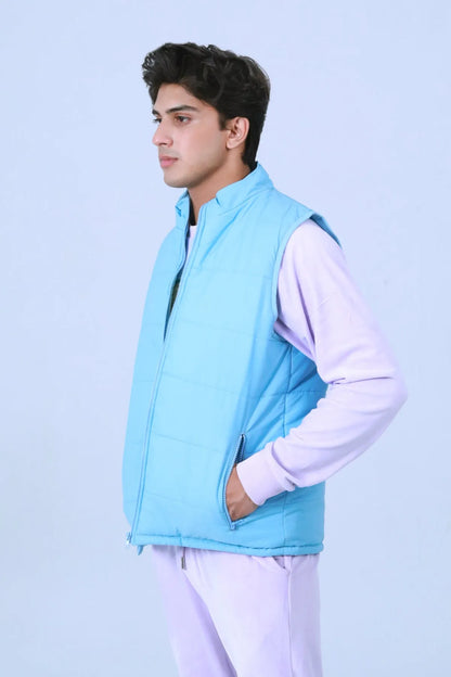 Blue quilted puffer vest with hood, zip front and side seam styling