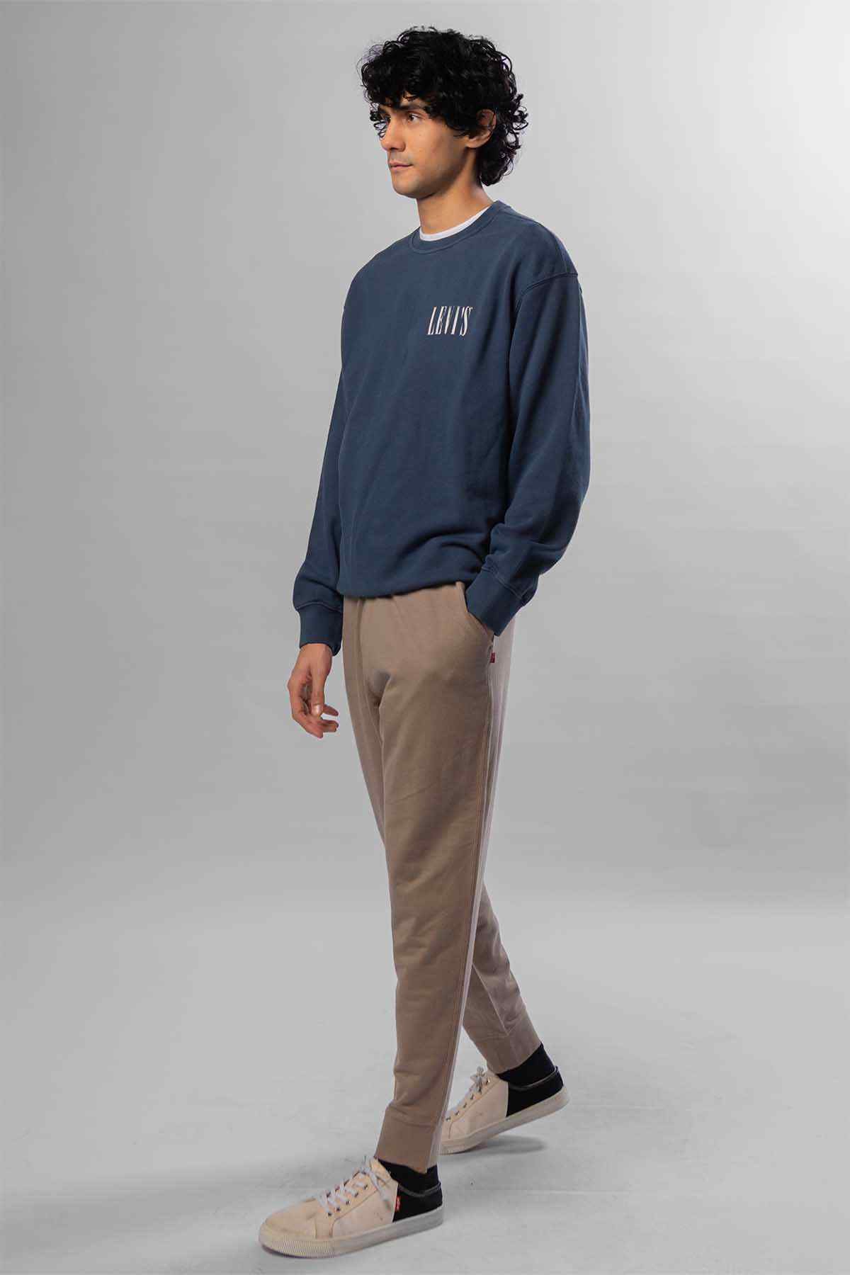 Levi's navy crewneck sweatshirt with small chest logo; beige tapered pants