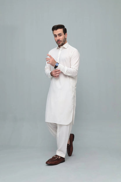 Men's white shalwar suit with long kurta and shalwar, angled pose