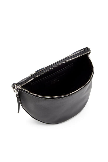 Black half-moon belt bag with zip closure and visible interior opening