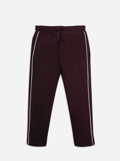 Burgundy cotton track pants with elastic waistband, drawstring, and white side stripes
