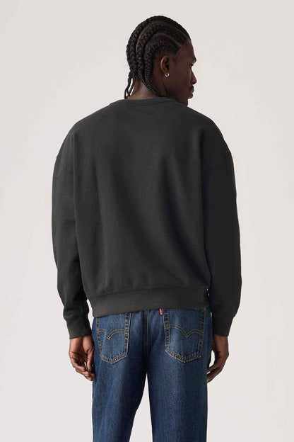 Back view of black crewneck sweatshirt with ribbed cuffs, relaxed fit