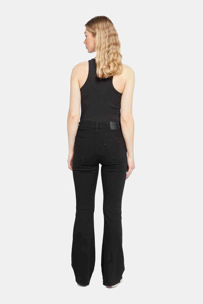 Levi's black sleeveless logo top and black jeans, back view