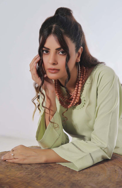 Light green tunic and pants set, close-up of long sleeves and neckline