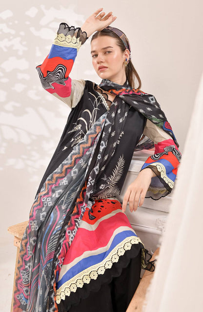Long black patterned dress with bold red, blue, and cream print and lace border