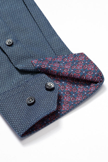 Blue button-down cuff with red patterned underside and dark button