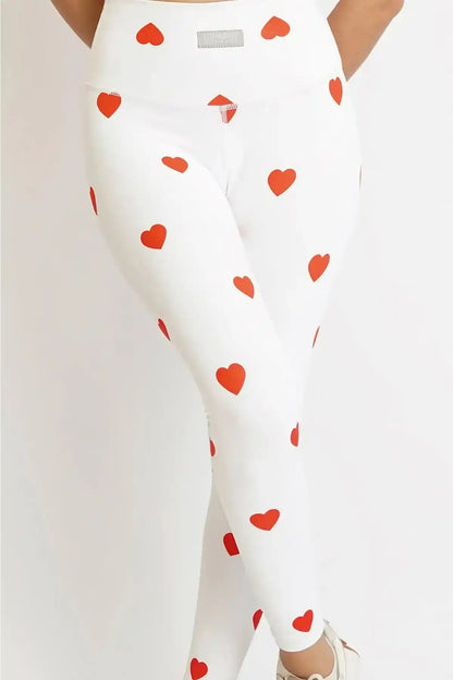 White leggings with red heart and icon print, high-rise fit, close-up.