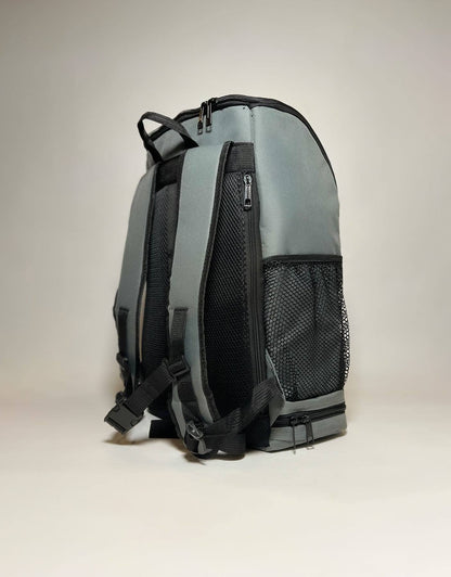 Gray backpack side view with mesh panel and zipper pocket