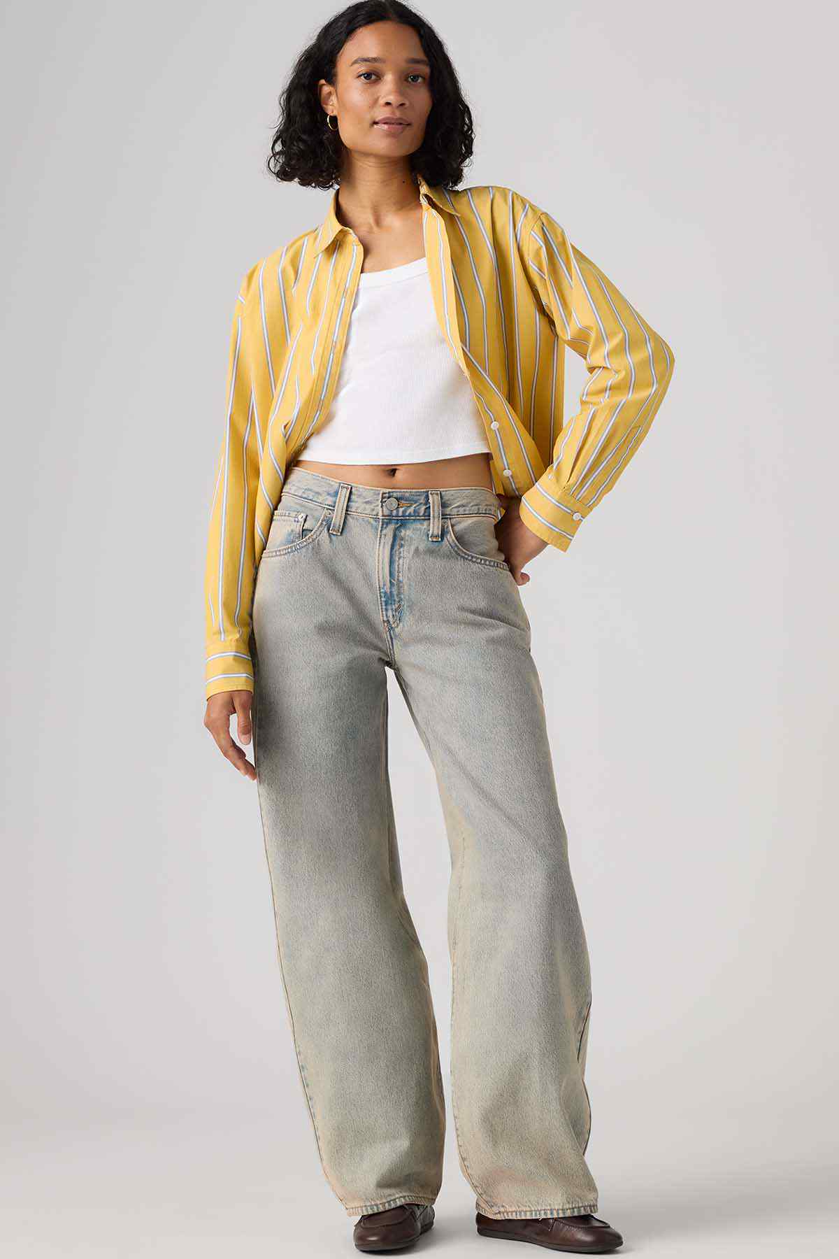 Levi's white camisole and light gray wide-leg jeans with yellow striped shirt