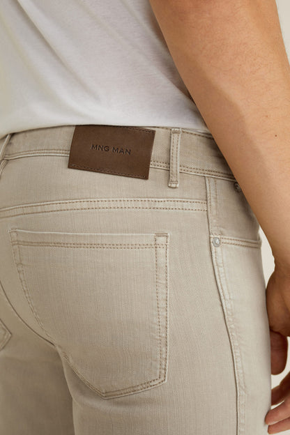 Beige MNG man jeans label on back pocket, contrast stitching, and belt loop