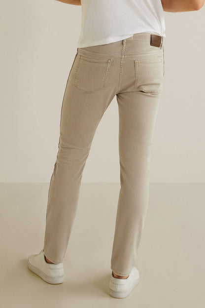 Beige slim denim jeans, belt loops, zip fly, and stitched front pockets