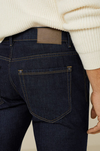 Dark blue denim jeans close-up of back pocket with leather patch label