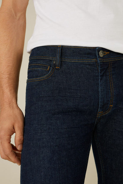 Dark blue denim jeans close-up of front pocket and belt loops