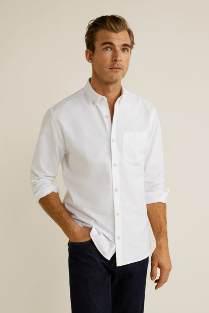 White button-up shirt with long sleeves and button front, chest pocket detail