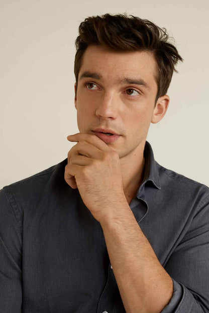 Open grey button-up shirt collar with buttons, close-up