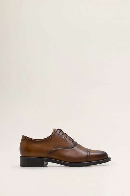 Brown leather lace-up oxford shoes with black sole, single side view