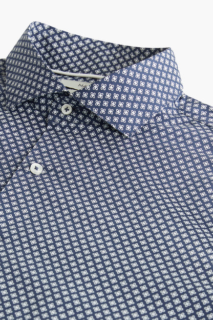 Navy patterned dress shirt close-up: button placket and pointed collar
