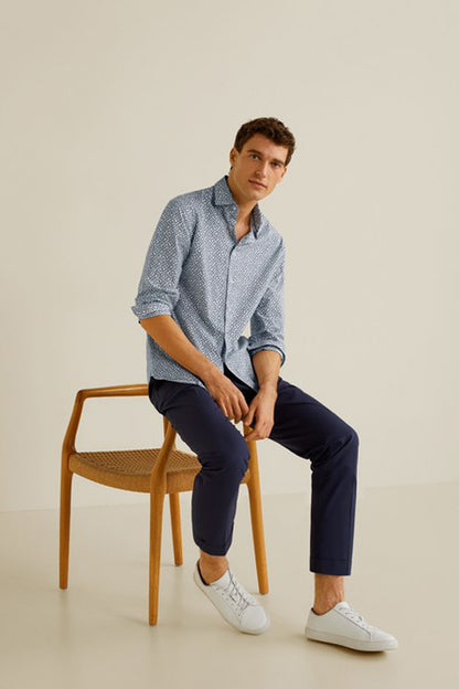 Men's light blue patterned button-up shirt with collar and rolled sleeves