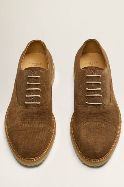 Pair of dark brown suede lace-up shoes with laces and tan rubber sole
