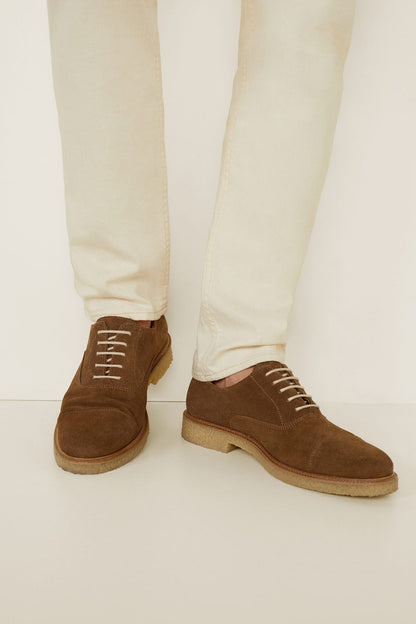 Brown suede lace-up shoes with tan sole and stitched trim
