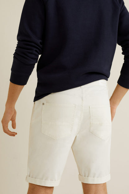 White cuffed denim shorts with side pockets and visible stitched seams