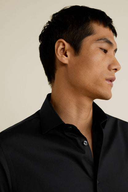 Men's black button-up shirt collar and front placket close-up