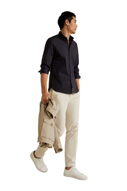Men's dark button-up shirt with rolled sleeves, front three-quarter view
