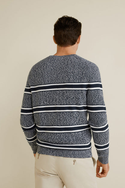 Back view: dark knit sweater with white and navy horizontal stripe bands