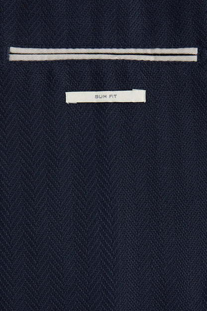 MANGO blazer close-up: 'SLIM FIT' label and striped inner collar trim