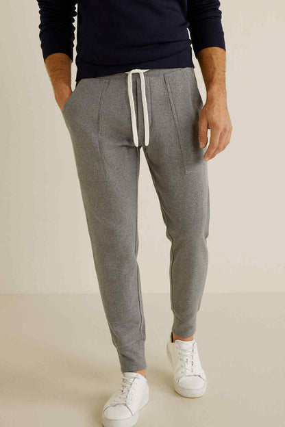 Grey drawstring jogger pants with white tie and front pockets