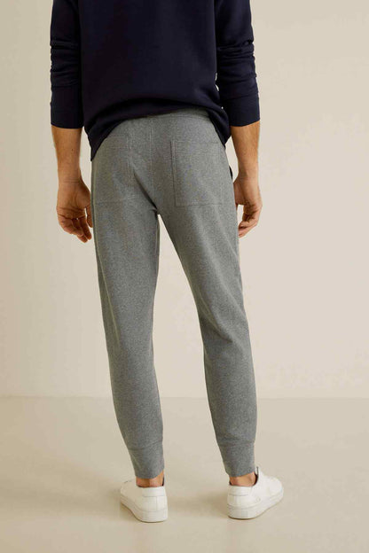Grey jogger pants with elastic cuffs and vertical seaming
