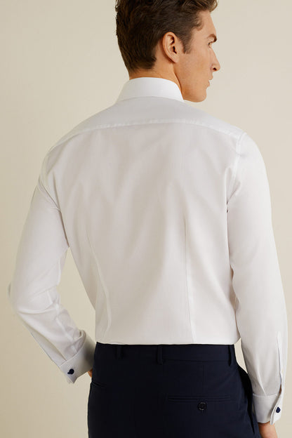 White button-up dress shirt from behind with long sleeves and button cuffs
