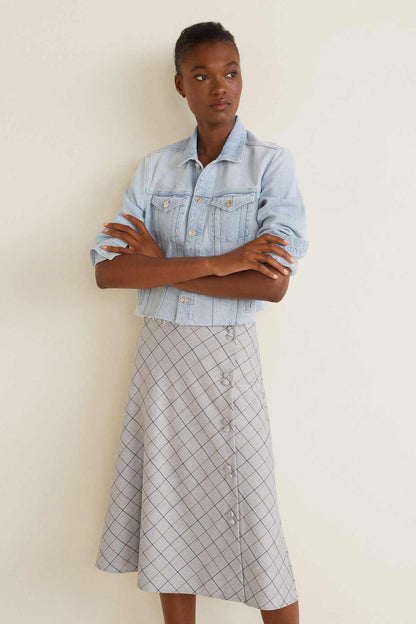 Light blue denim jacket and white grid midi skirt, button-front with folded cuffs