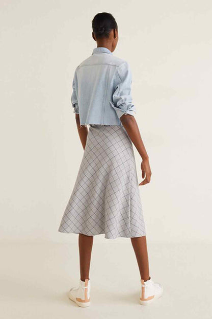 Back view: light blue denim jacket and white grid midi skirt, flared hem